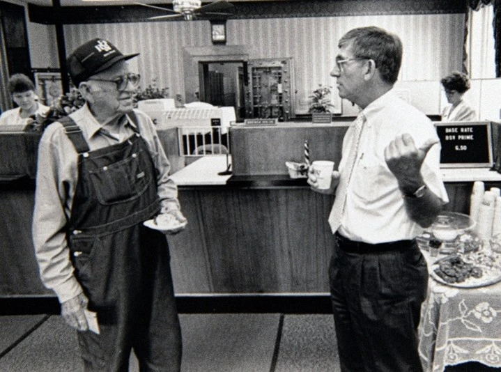 Former BSV Chairman Johnny Clements speaking with customer Wilfred Harville in 1991
