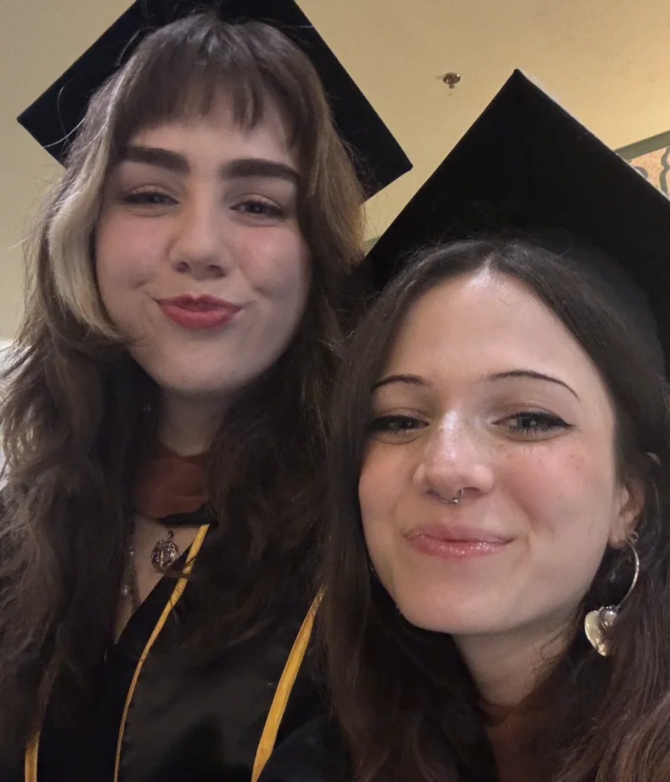 Two young adults celebrating their graduation