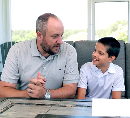 Parent talking with a child about saving money